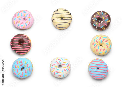 Frame made of delicious donuts on white background