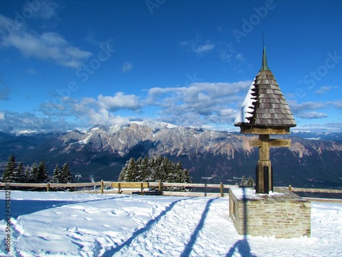 View of mountain Dobratsch, Dobrac in Carinthia or Karnten, Austria in Gailtal Alps with a structure marking the border bettwen Austria, Slovenia and Italy photo