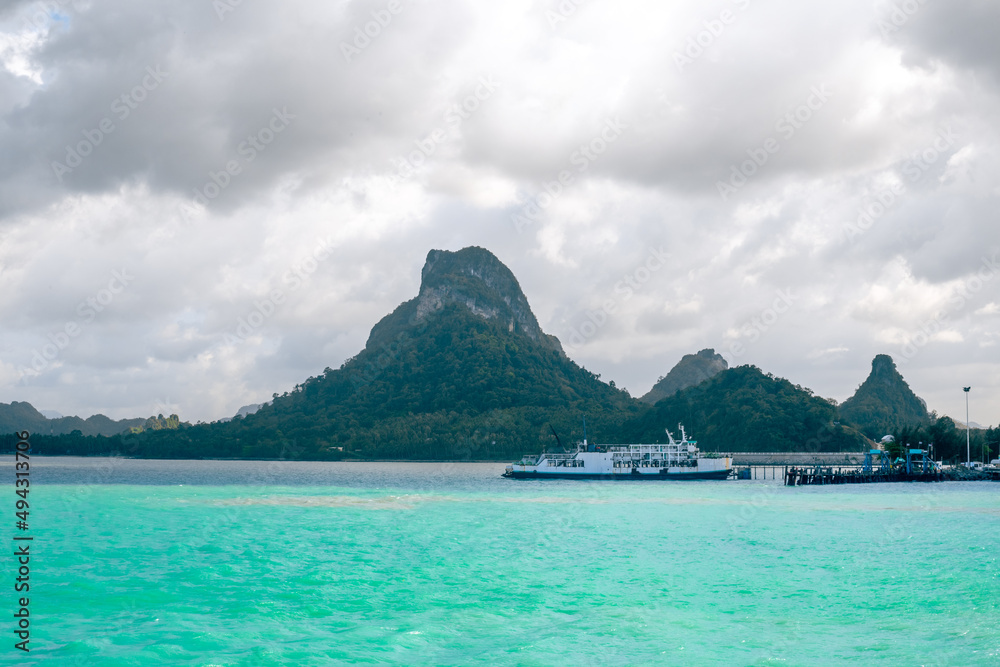 Seascape. Ferries stand in the sea against the backdrop of beautiful bizarre mountains. Travel and tourism