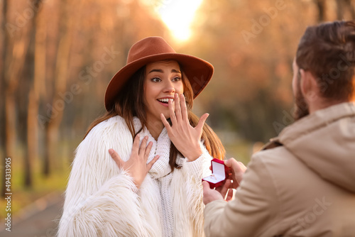 Young man proposing to his ...