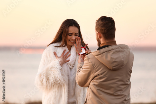 Young man proposing to his ...