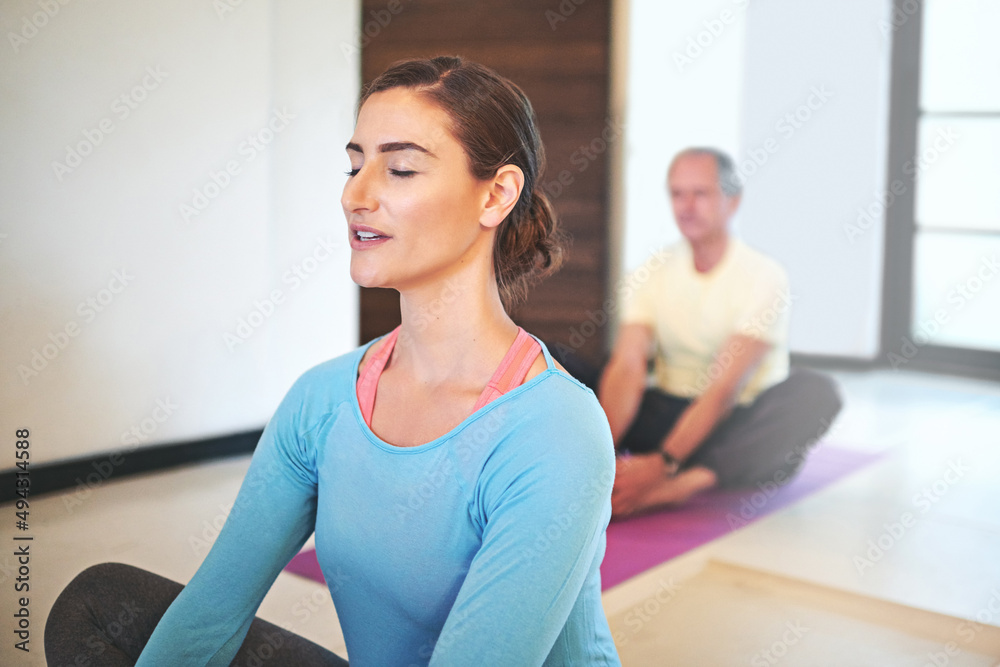 Working through some breathing exercises. Cropped shot of a yoga instructor guiding a senior man in a yoga class. Working through some breathing exercises. Cropped shot of a yoga instructor guiding a senior man in a yoga class.