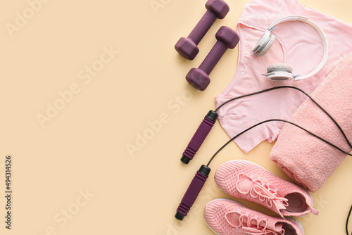 Fototapeta Naklejka Na Ścianę i Meble -  Sportswear, shoes, headphones and equipment on color background