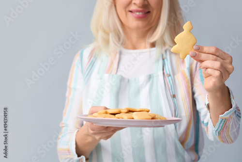 Mature woman holding plate ...