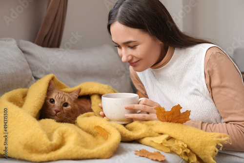 Woman with cute ginger cat ...