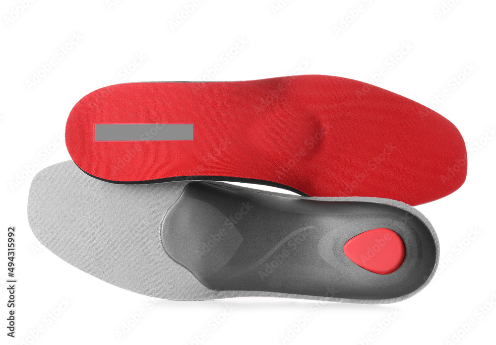 Red orthopedic insoles on white background