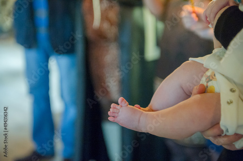 christening of little baby in church, close-up feet and priest hand. High quality photo