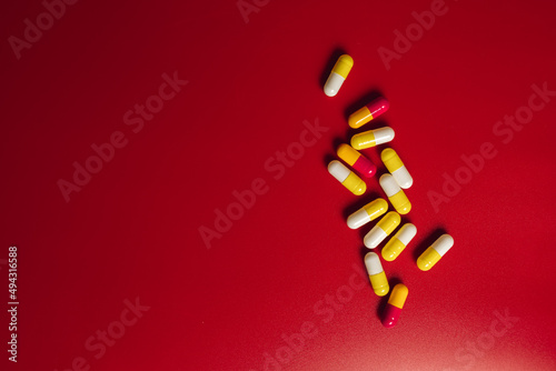 colored pills on red background