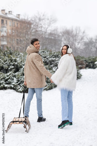 Loving couple with sledge i...
