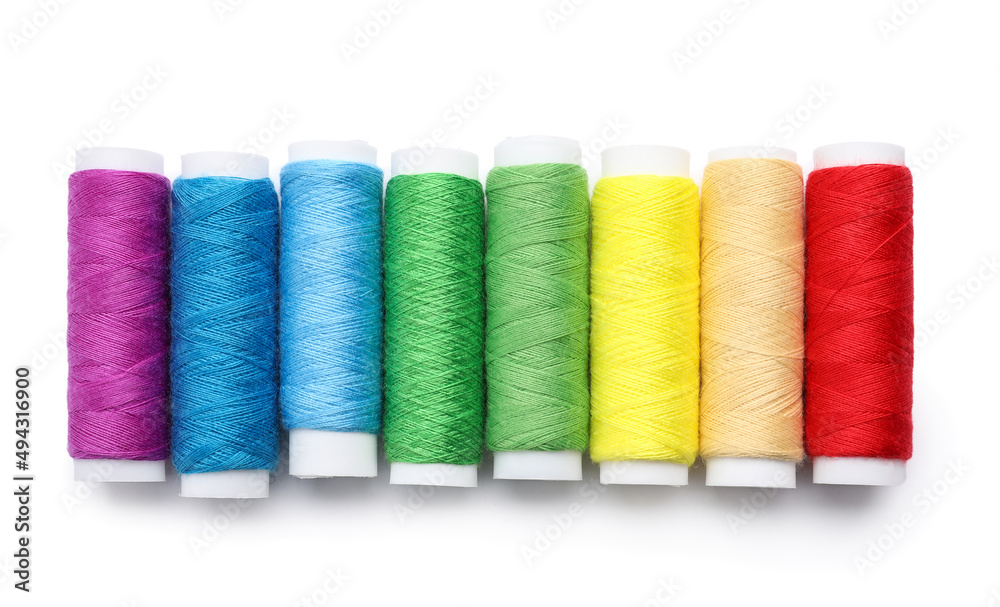 Multicolored sewing thread spools on white background Multicolored sewing thread spools on white background