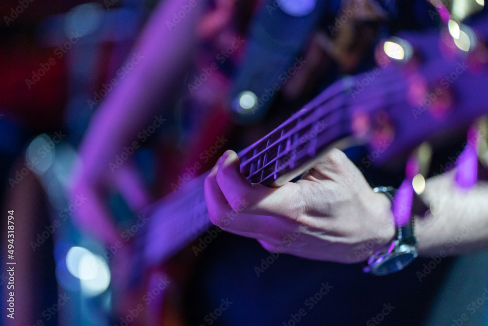 Naklejka premium unrecognizable person. Plucking the strings of the electric guitar at a concert