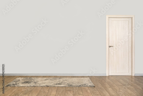 View of big empty room with door and carpet