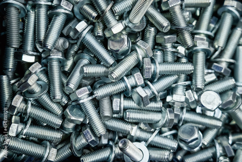 Metal screw bolts top view as industrial equipment background. photo