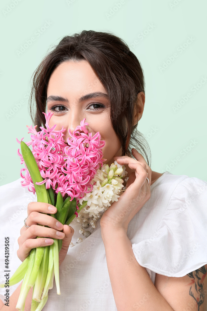 Pretty young woman with hyacinth flowers on green background Pretty young woman with hyacinth flowers on green background