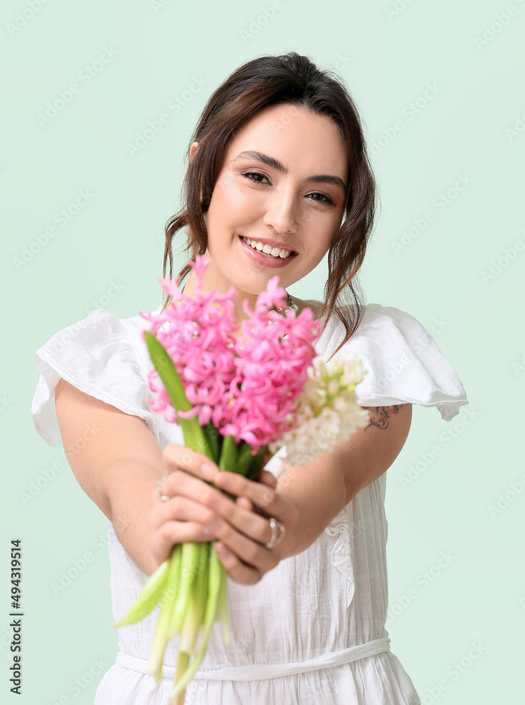Pretty young woman with hyacinth flowers on green background Pretty young woman with hyacinth flowers on green background