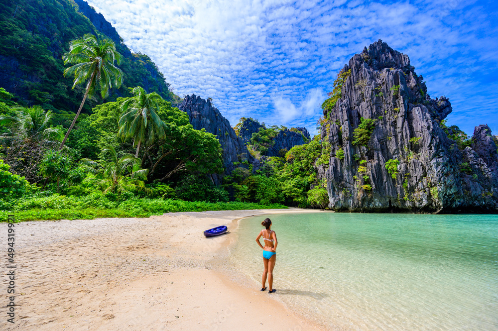 Girl at Hidden Beach in Matinloc Island, El Nido, Palawan, Philippines - Paradise lagoon and beach in tropical scenery