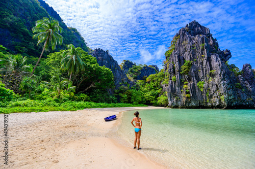 Girl at Hidden Beach in Matinloc Island, El Nido, Palawan, Philippines - Paradise lagoon and beach in tropical scenery photo
