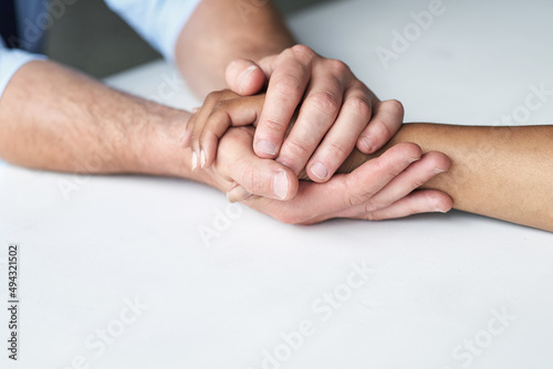 Well get through this together. Cropped shot of two people holding hands in comfort.