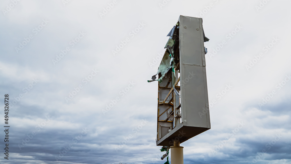 Broken sign after storm in the wind