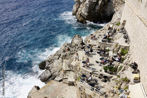 Fototapeta Naklejka Na Ścianę i Meble -  Aerial top view of the rocky coast and the sea washing it in Dubrovnik, Croatia