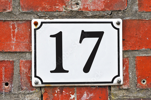 White house number plaque, showing the number seventeen photo