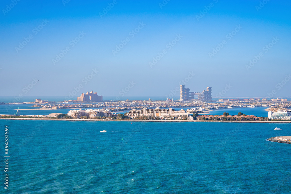 Beautiful port with city at jumeirah island against clear blue sky