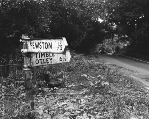 Black and white shot of a road signs with street names 