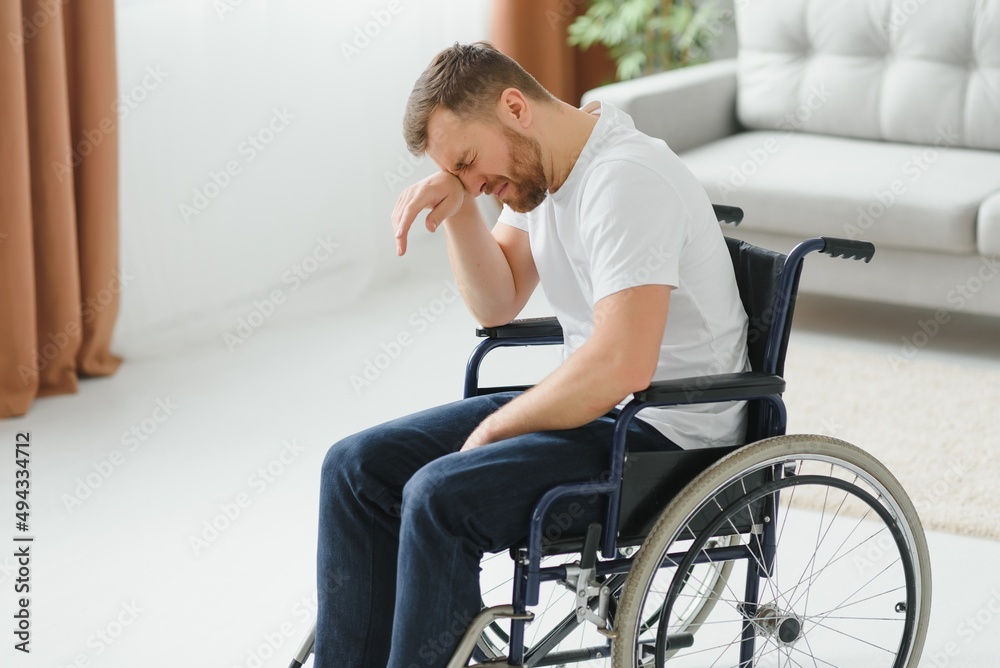 Disabled young man suffering at home Disabled young man suffering at home