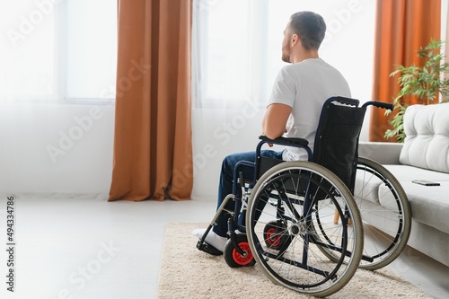 Depression and loneliness in disabled man. Elderly man in wheelchair crying indoors