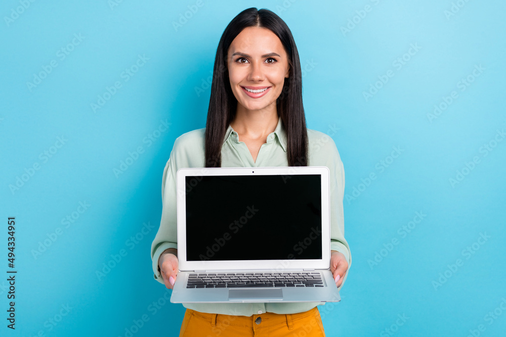 Portrait of gorgeous young businesswoman promote you new working laptop sale discount isolated on blue color background Portrait of gorgeous young businesswoman promote you new working laptop sale discount isolated on blue color background