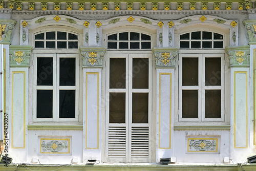 Singapore Straits Chinese Peranakan shophouse with arched windows, white louvers,ornate columns photo