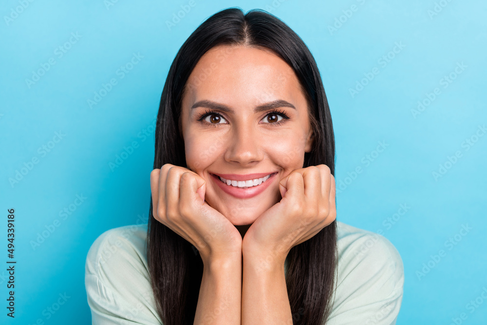 Fototapeta premium Photo of young adorable woman good mood hands touch cheeks dream isolated over blue color background