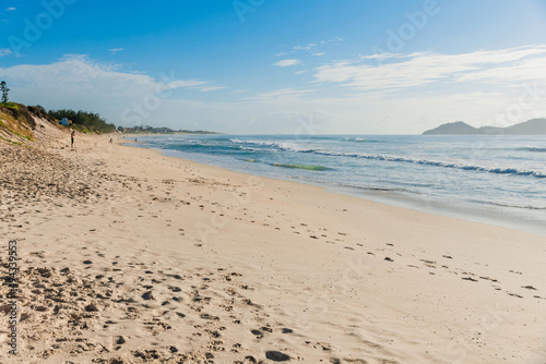 Holiday beach and ocean with waves in Brazil. Morro das Pedras beach in Florianopolis