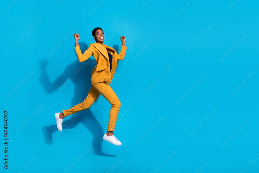 Full size profile side photo of young man woman celebrate success luck runner jumper fast isolated over blue color background