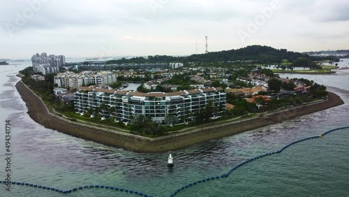 Aerial drone clip of Sentosa island in 4k featuring Sentosa cove residence a- Panning shot photo