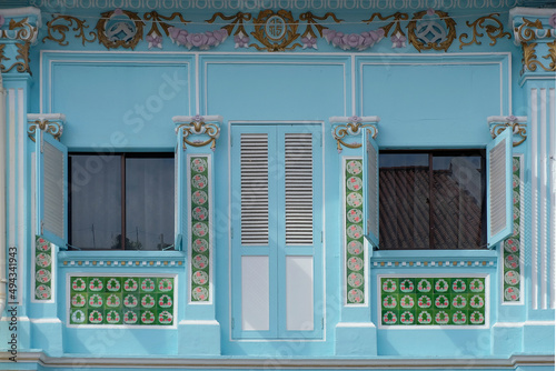Straits Chinese Peranakan exterior with wooden louvers, rococo designs and floral mosaic tiles photo