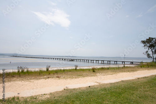 Scenic view of the longest wooden jetty on the Tuggerah Lakes in  Central Coast on a sunny day photo