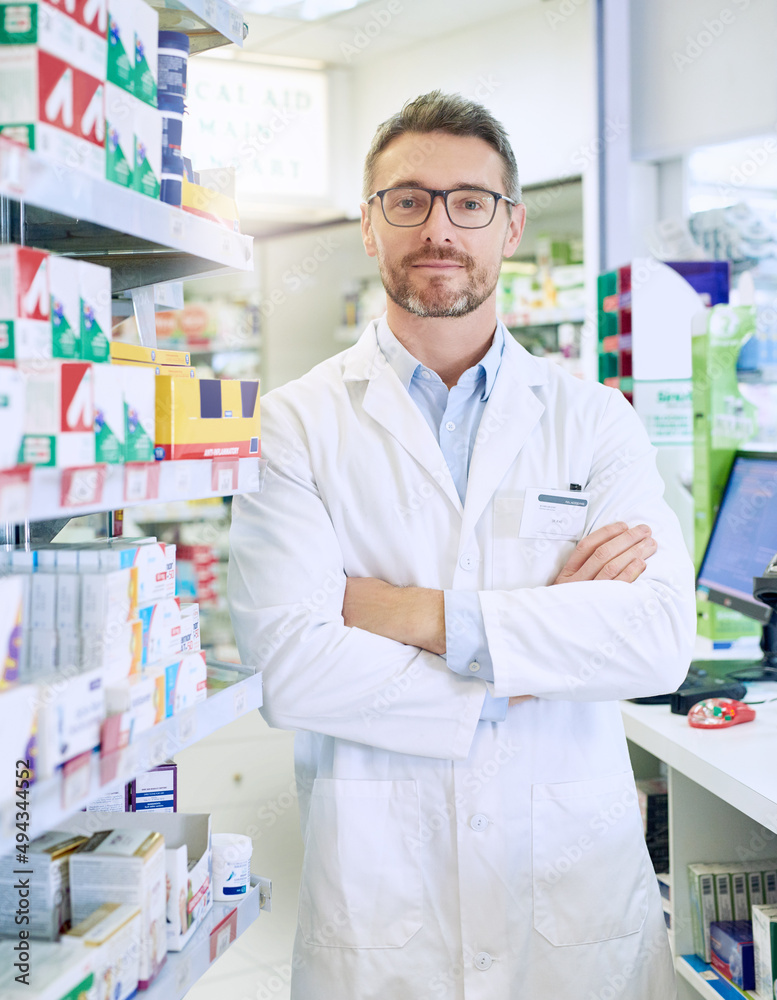 Hes equipped with the necessary skills to to improve your health. Portrait of a confident mature pharmacist working in a pharmacy.