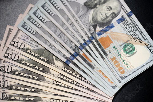 Fifty and one hundred US Dollar banknotes spread out