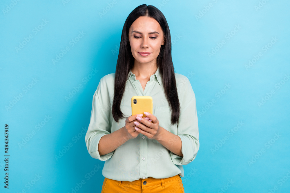 Photo of serious businesswoman browsing online see notification receive like isolated on blue color background Photo of serious businesswoman browsing online see notification receive like isolated on blue color background