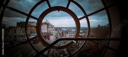 Closeup of a round window with a street in the background photo