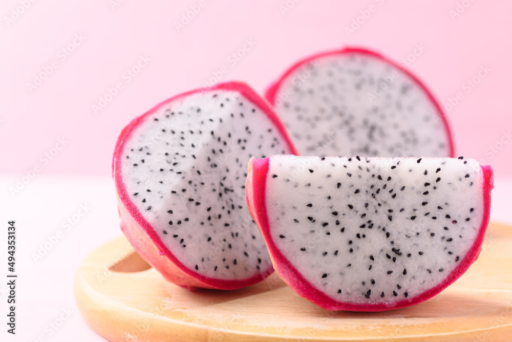 Close up of sliced dragon fruit or pitaya on wooden, Tropical fruit Close up of sliced dragon fruit or pitaya on wooden, Tropical fruit