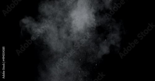 An explosion of dust from the ashes on a black background.