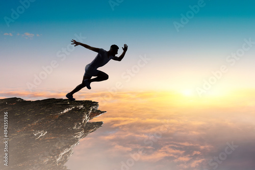 Wallpaper Mural Man running against sunset sky background . Mixed media Torontodigital.ca