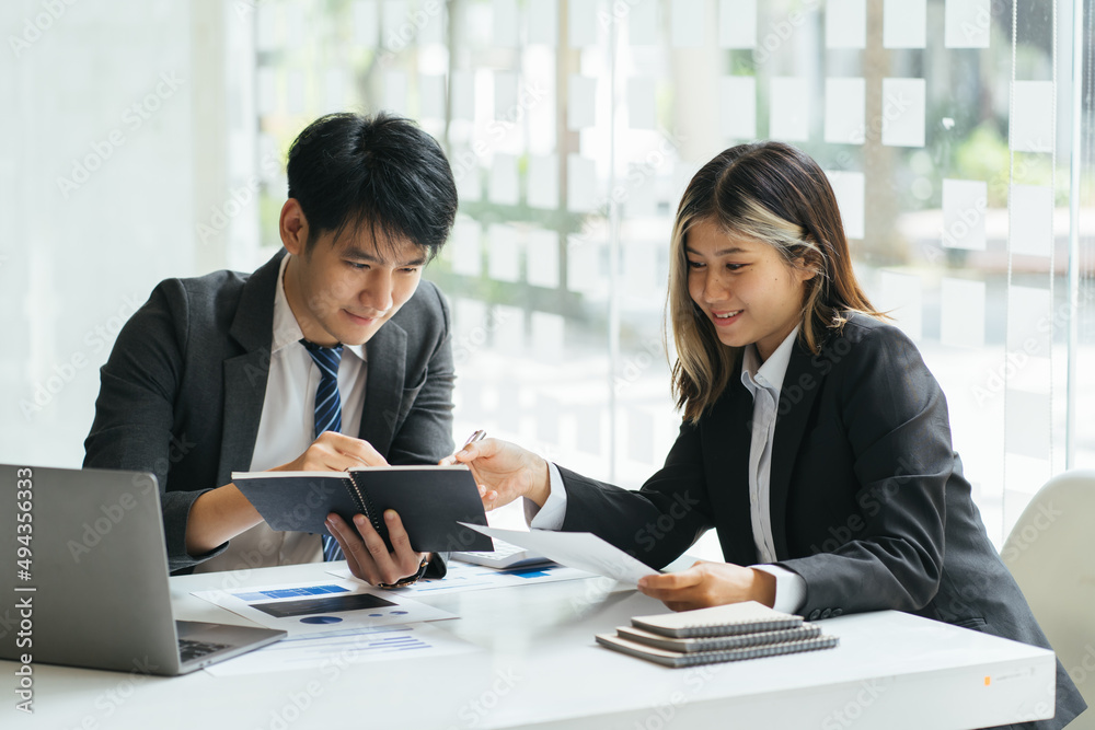 Young business people and partners are analyzing sales figures this year to improve sales next year. Young business people and partners are analyzing sales figures this year to improve sales next year.
