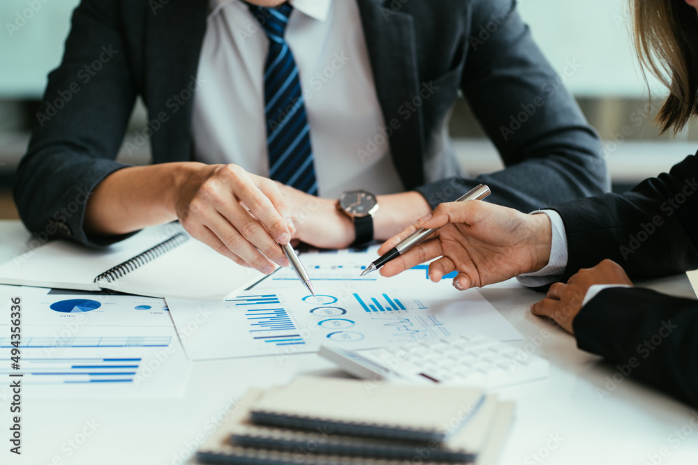 Business people meeting explaining the financial graph data and marketing plan. Group of business people at meeting assessment the state of business investment and marketing.