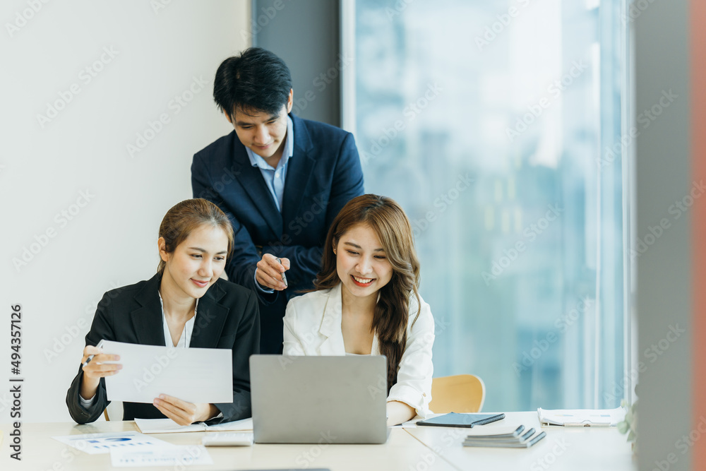 group of four happy young asian corporate people teammates meeting discussing business in office.