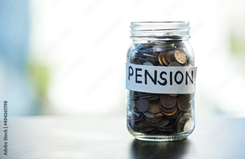 Save every dime and dollar. Shot of a pension money jar on a table at home. Save every dime and dollar. Shot of a pension money jar on a table at home.