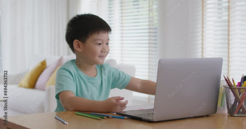 Cute pupil child gen z alpha boy sit talk video call self e-learning lesson on laptop at home table. Asia art school tutor class drawing color pencil in paper enjoy fun social media upskill kid. Cute pupil child gen z alpha boy sit talk video call self e-learning lesson on laptop at home table. Asia art school tutor class drawing color pencil in paper enjoy fun social media upskill kid.
