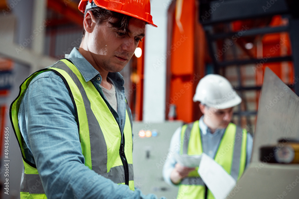 Chief engineer is looking at a work that he is making or checking security system setup at metal lathe industrial manufacturing. Chief engineer is looking at a work that he is making or checking security system setup at metal lathe industrial manufacturing.